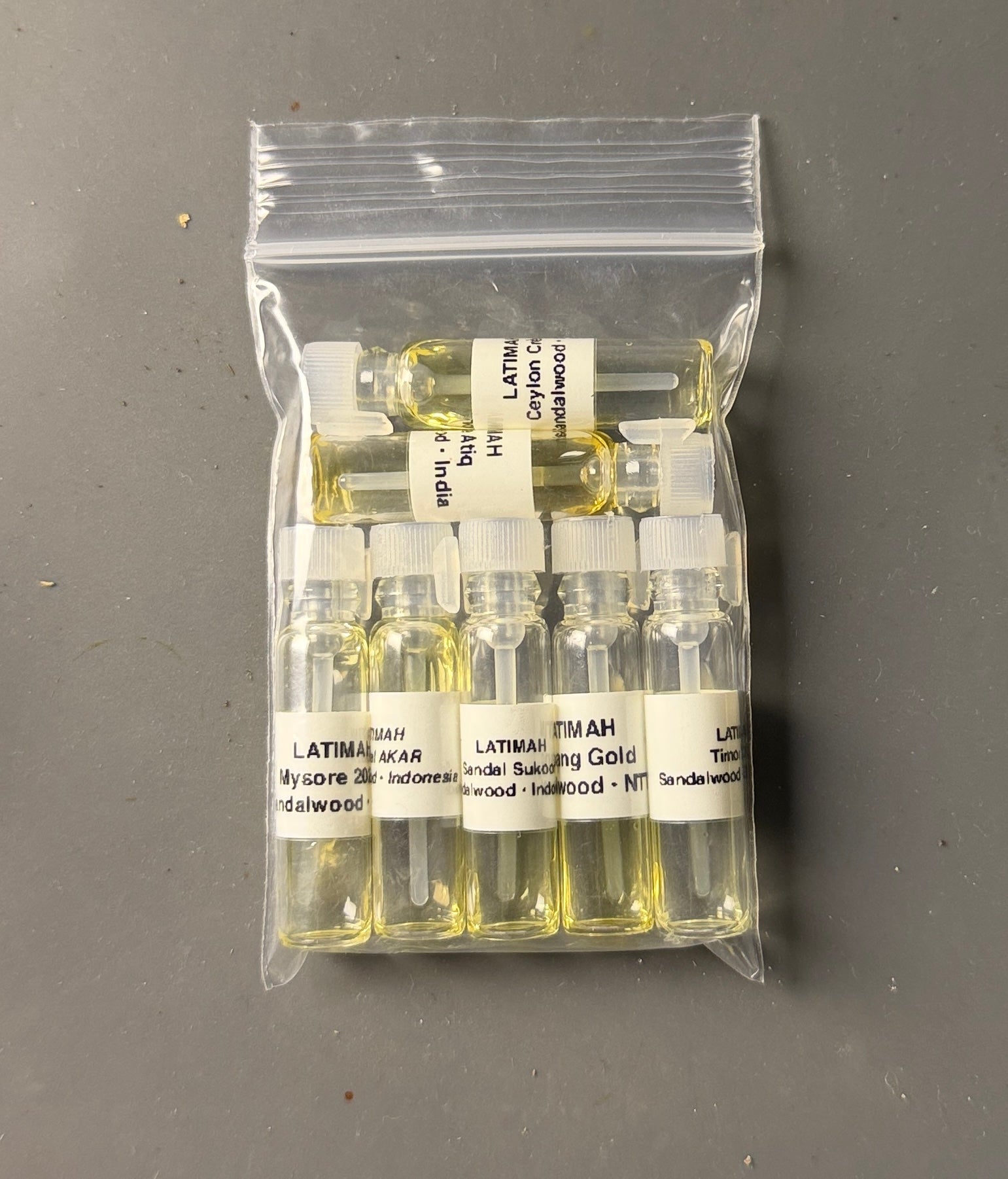 Packaged sample vials with labels on a gray background
